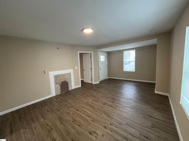 unfurnished living room featuring dark hardwood / wood-style flooring