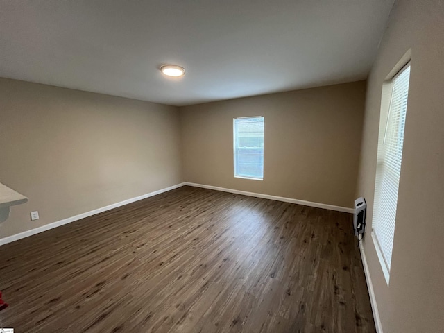 unfurnished room featuring dark hardwood / wood-style flooring