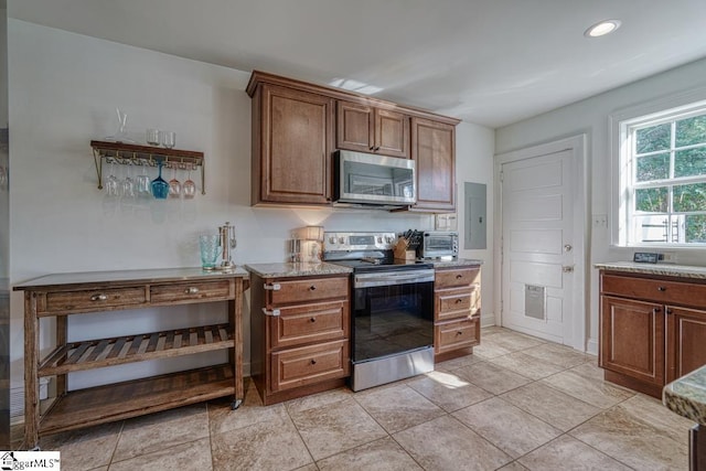 kitchen with electric panel and appliances with stainless steel finishes