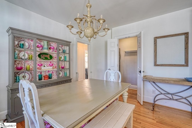 dining area with a chandelier and light wood-type flooring