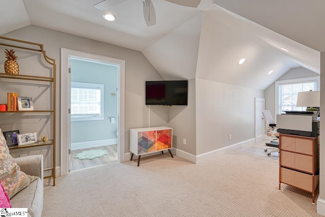 office featuring lofted ceiling, light carpet, and ceiling fan