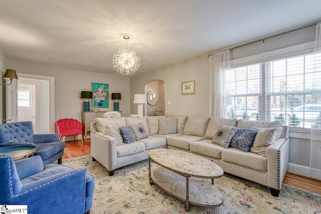 living room with hardwood / wood-style flooring and a chandelier