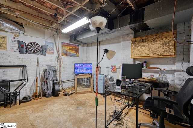 home office with concrete floors and brick wall