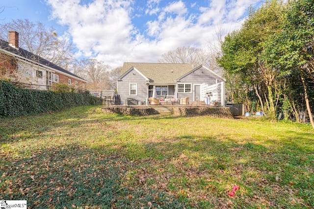 rear view of house featuring a yard