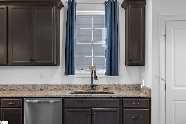 kitchen with light stone counters, plenty of natural light, dishwasher, and sink