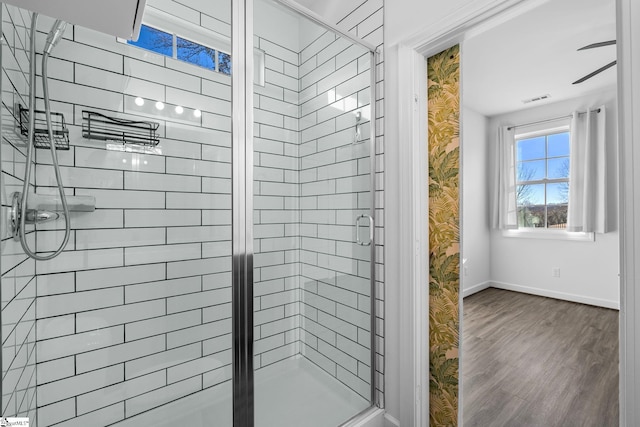 bathroom with hardwood / wood-style flooring and walk in shower