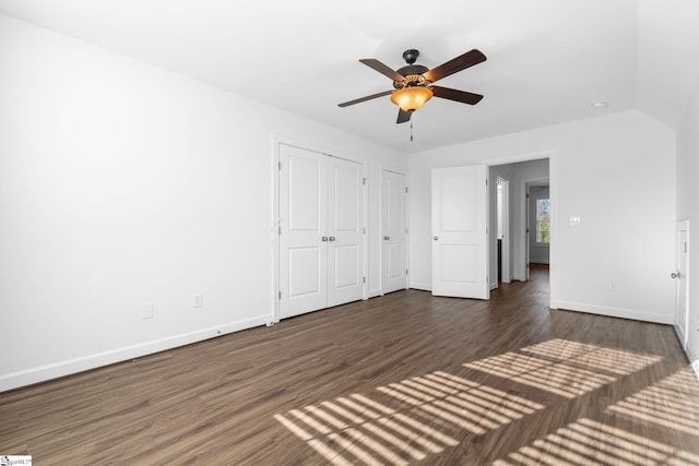 unfurnished bedroom featuring vaulted ceiling, dark hardwood / wood-style floors, and ceiling fan