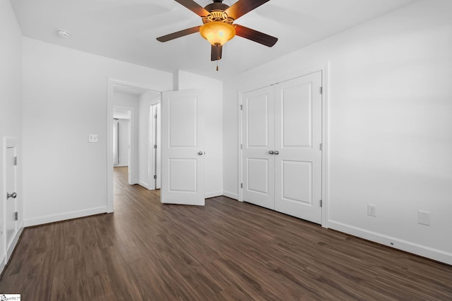 unfurnished bedroom featuring dark hardwood / wood-style floors, ceiling fan, and a closet