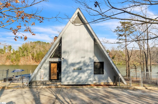 back of property featuring a water view