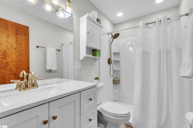 bathroom featuring vanity, curtained shower, and toilet