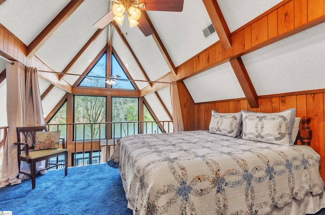 bedroom featuring carpet, vaulted ceiling with beams, and wooden walls