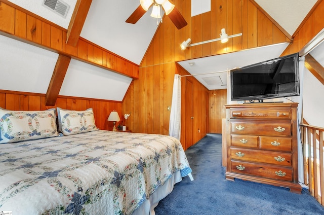 bedroom with dark colored carpet, vaulted ceiling, and wooden walls