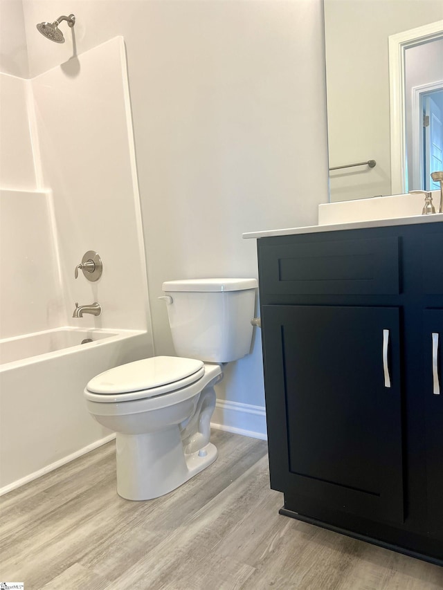 full bathroom featuring vanity, hardwood / wood-style floors,  shower combination, and toilet