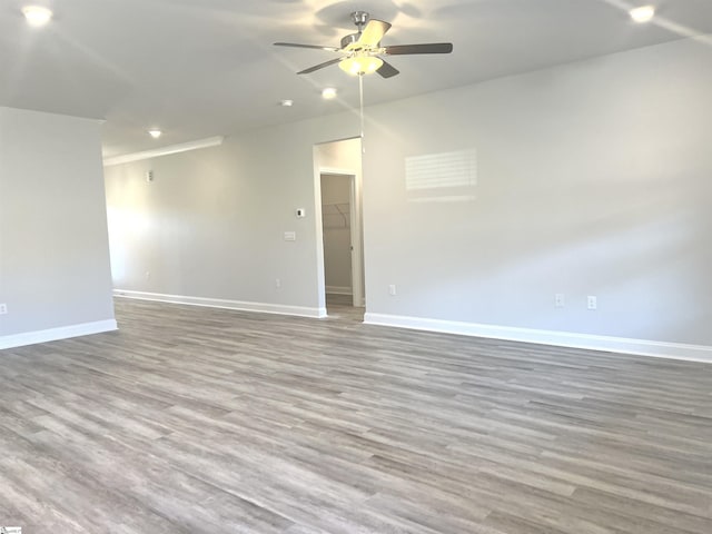 empty room with wood-type flooring and ceiling fan