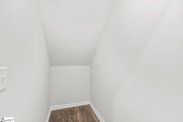 interior space with wood finished floors and baseboards