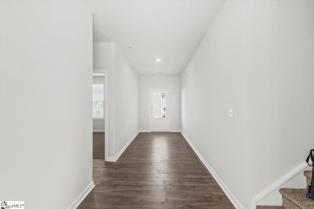 entryway featuring stairs, baseboards, and dark wood-style flooring