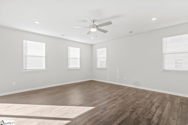 spare room with dark wood-style floors, ceiling fan, recessed lighting, and baseboards