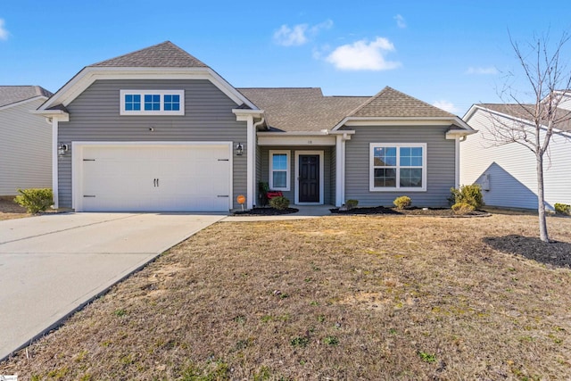 view of front of home with a garage and a front yard