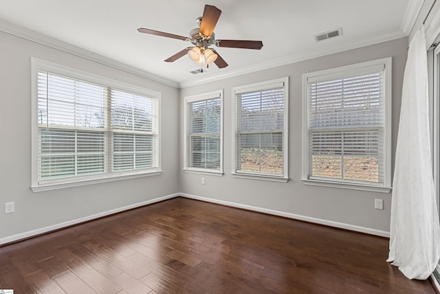 empty room featuring crown molding, dark wood-type flooring, and ceiling fan