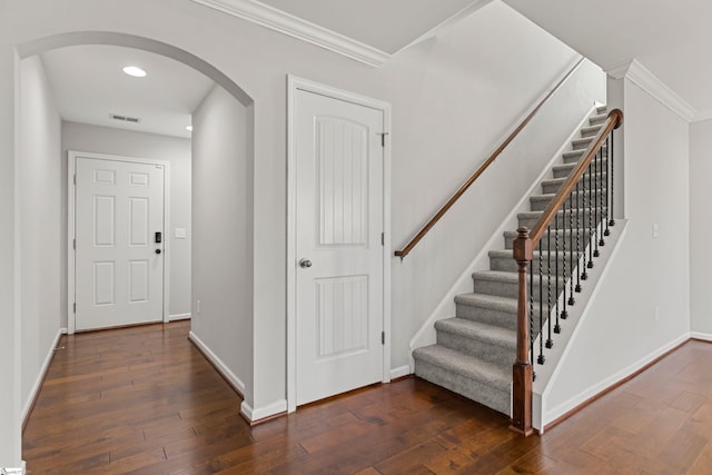 stairs featuring hardwood / wood-style flooring and crown molding