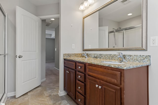 bathroom featuring vanity and a shower with shower door