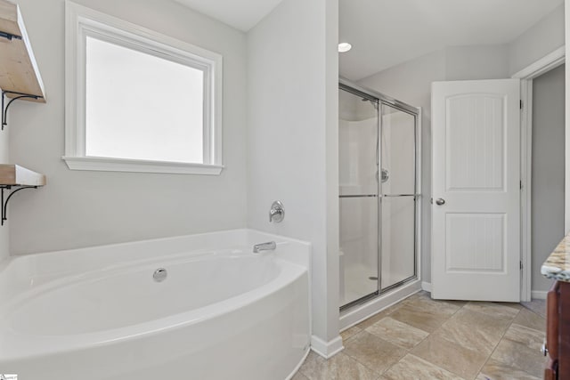 bathroom with vanity and shower with separate bathtub