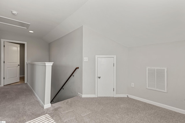 interior space with lofted ceiling and light carpet