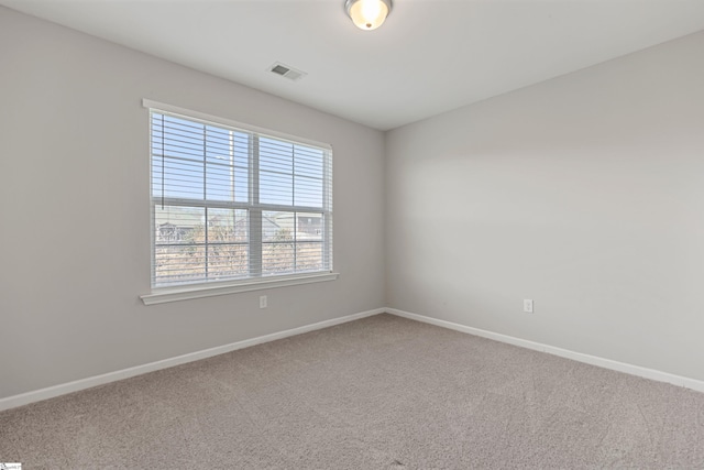 spare room featuring carpet