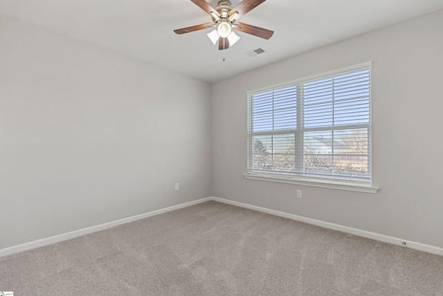 carpeted empty room featuring ceiling fan