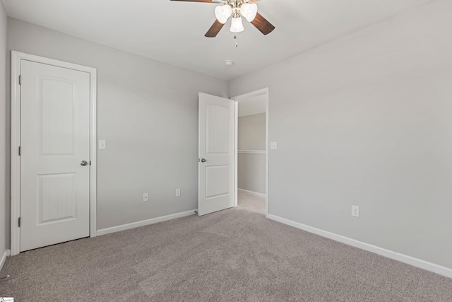 unfurnished bedroom featuring light colored carpet and ceiling fan