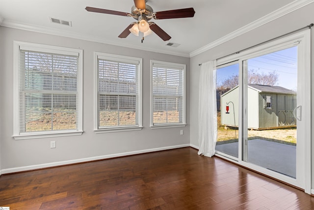 empty room with ornamental molding, dark wood-type flooring, and ceiling fan