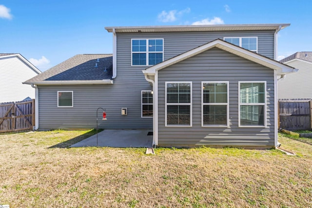 rear view of property with a yard and a patio area