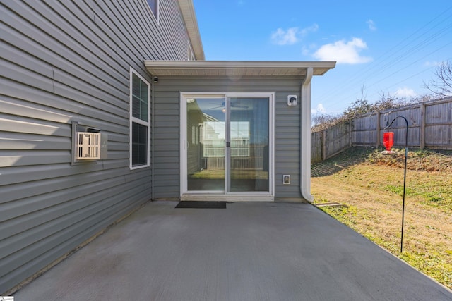 view of exterior entry featuring a patio area