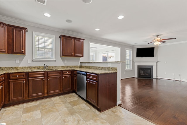 kitchen with ornamental molding, dishwasher, sink, and a wealth of natural light