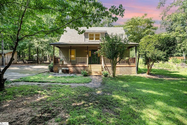 view of front of house with a lawn and covered porch