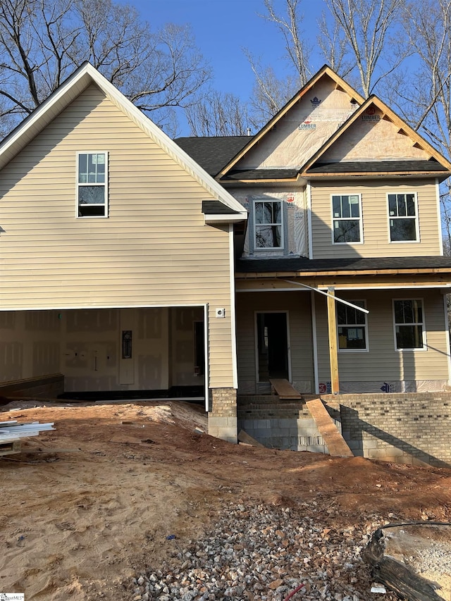 view of front facade with a garage and covered porch