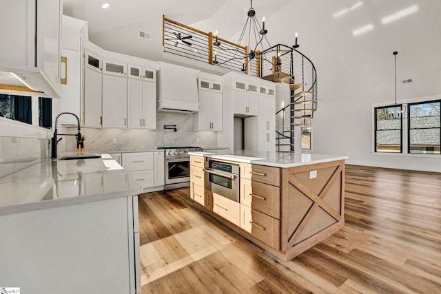 kitchen with white cabinetry, a spacious island, and stainless steel appliances