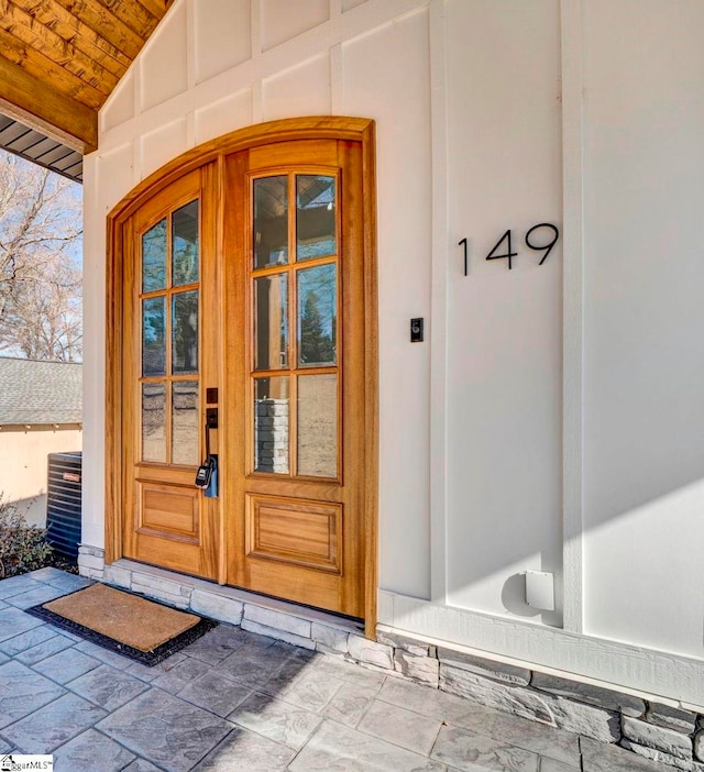 view of exterior entry with french doors and central air condition unit