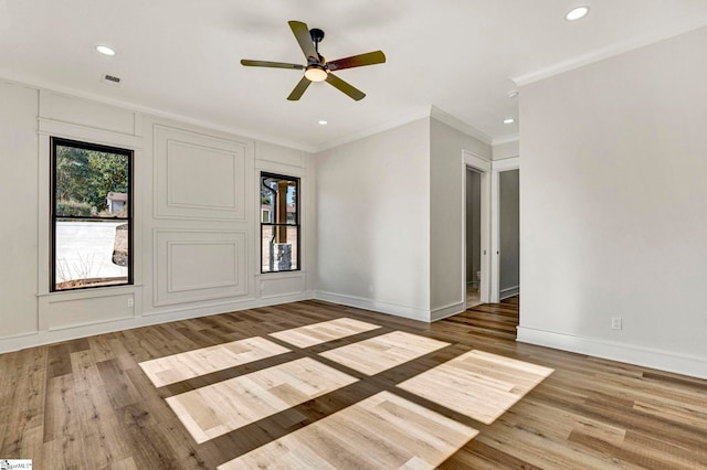 spare room featuring ceiling fan, ornamental molding, and wood-type flooring