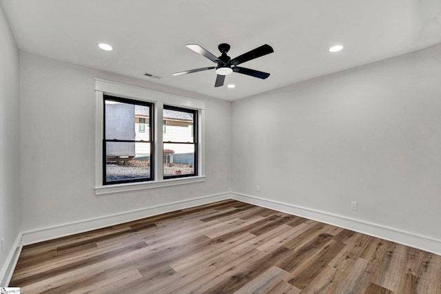 spare room featuring hardwood / wood-style floors and ceiling fan