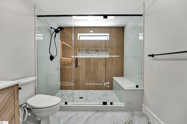 bathroom featuring vanity, a shower with door, and toilet