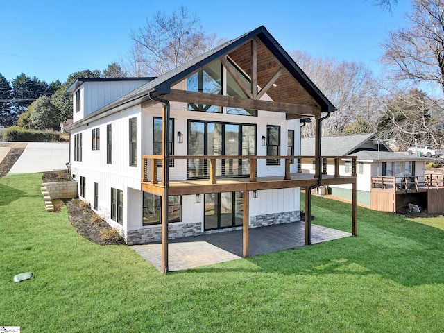 rear view of property with a patio area and a lawn