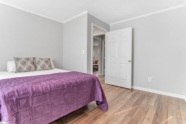 bedroom with hardwood / wood-style floors and crown molding