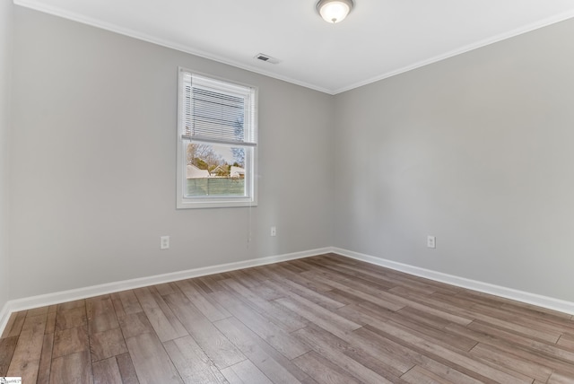 unfurnished room with crown molding and light hardwood / wood-style flooring