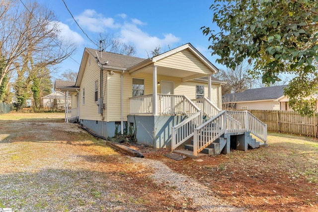 rear view of property featuring a porch