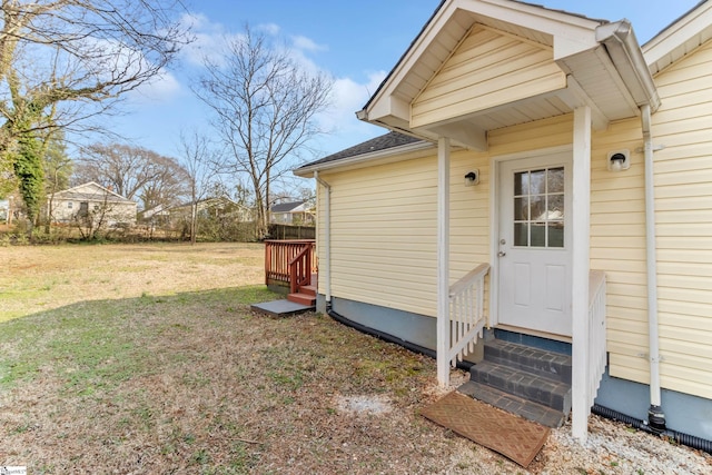 property entrance with a yard