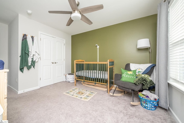 carpeted bedroom with a closet and ceiling fan