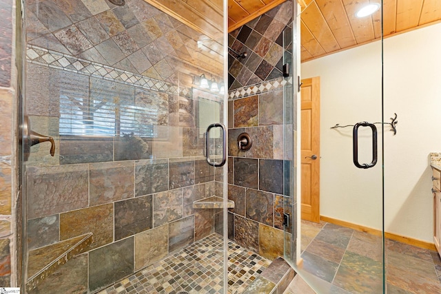 bathroom featuring vanity, a shower with shower door, and wooden ceiling