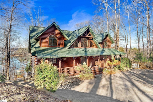 log home featuring covered porch