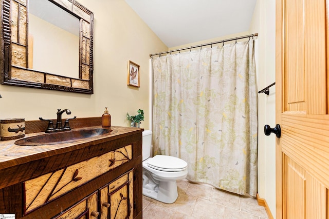 bathroom featuring vanity, toilet, and tile patterned flooring